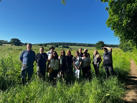 an image of 12 trustees on a sunny day stood in farmland