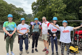 6 people stand in a row on millers dale bridge ready to abseil down it