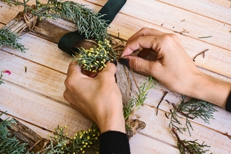 A person making a christmas wreath