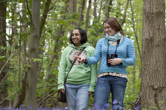 Bluebells - two young women walking in woodland