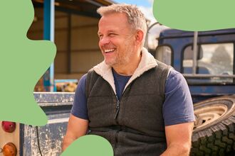 man sat on a farm vehicle