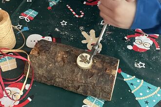 Christmas elf workshop - using a hand drill to make a decoration