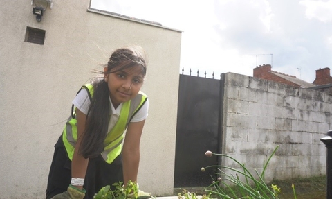 Child leaning on planter