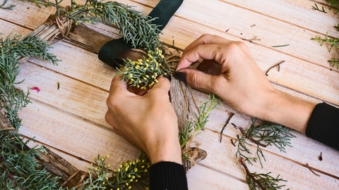 A person making a christmas wreath