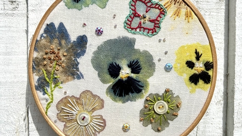 A completed embroidered ring with flowers decorated within it