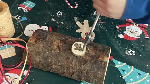 Christmas elf workshop - using a hand drill to make a decoration