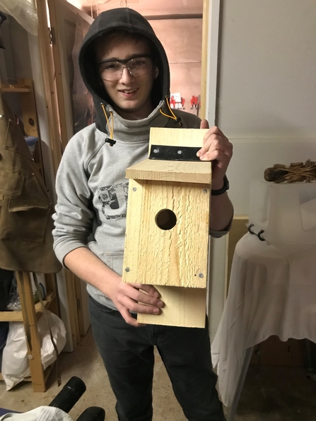 Junior Ranger Ben holding a bird box