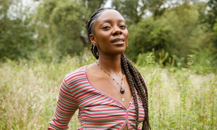 Joycelyn Longdon in a field of long grass