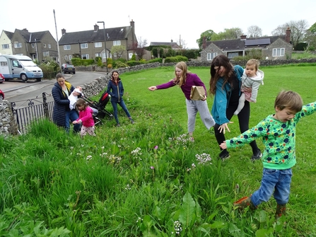 children and parents in a park playing in nature