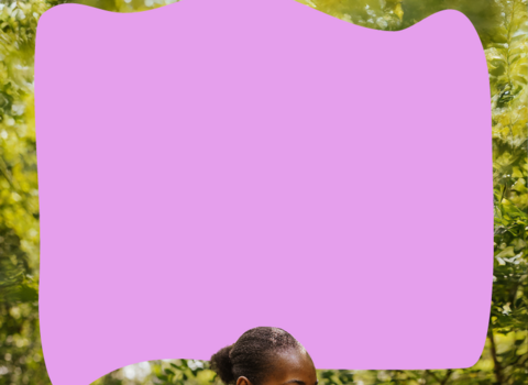 a woman stood amongst trees