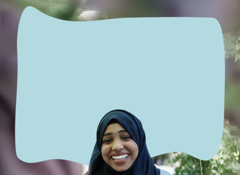 A person smiling and talking to someone